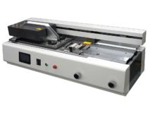 Industrial laminator or heat-sealing machine with front control panel and rollers on a pale orange background